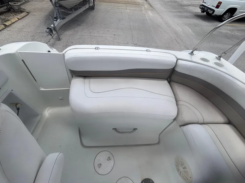 Slide: The Image of 2002 Monark Sunlounger 215 boat interior with white seating and storage compartment. - 24