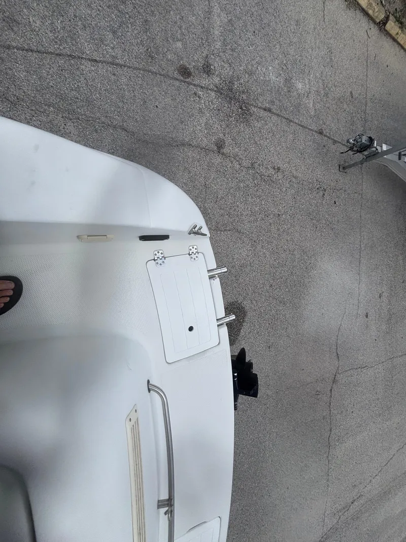 Slide: The Image of 2002 Monark Sunlounger 215 boat on pavement, showing rear deck and fittings. - 28