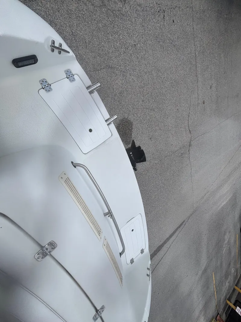 Slide: The Image of 2002 Monark Sunlounger 215 boat interior with white seating and metal railings. - 29