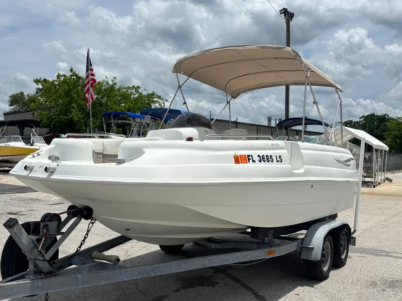 Slide: The Image of 2002 Monark Sunlounger 215 boat on trailer with canopy, parked outdoors. - 8