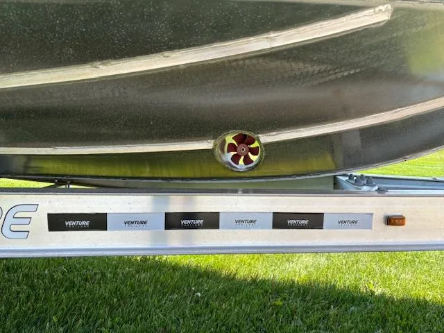 Slide: The Image of 2024 Alukin CW750 boat hull on Venture trailer, showcasing propeller detail. - 14