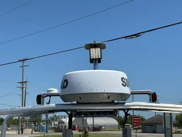 Slide: The Image of 2024 Alukin CW750 boat radar system with mounted light, under clear blue sky. - 6