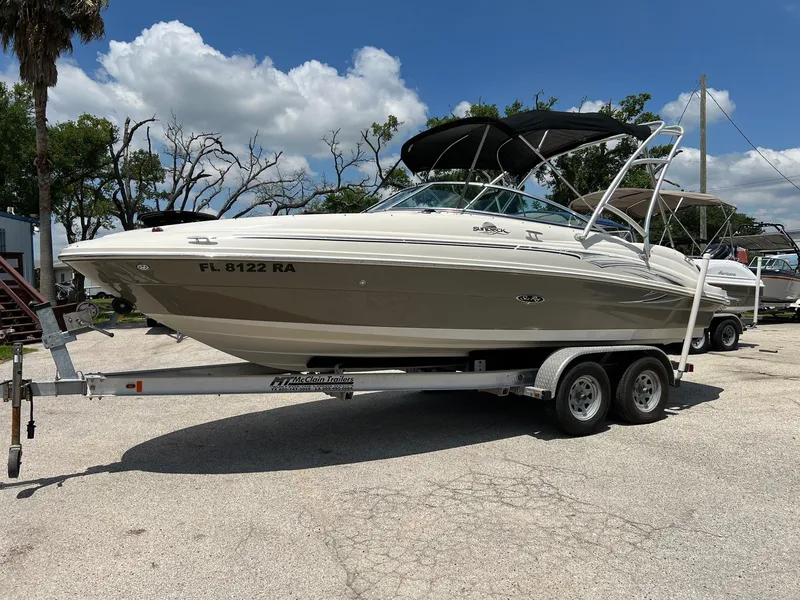 The Image of 2005 Sea Ray 220 Sundeck boat on trailer under clear sky. - 0