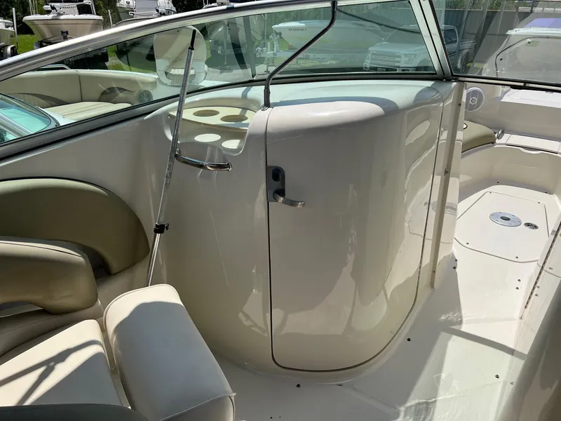 Slide: The Image of 2005 Sea Ray 220 Sundeck interior with seating and windshield, showcasing elegant design. - 10