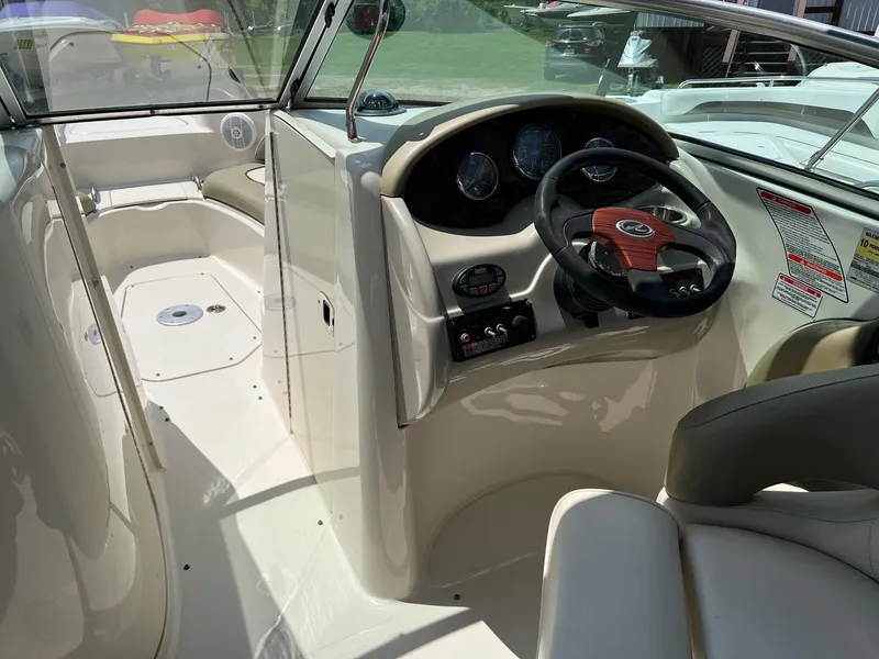 Slide: The Image of 2005 Sea Ray 220 Sundeck boat interior with steering wheel and dashboard. - 11