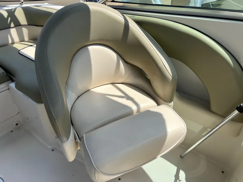 Slide: The Image of 2005 Sea Ray 220 Sundeck boat interior with beige and green seating. - 13