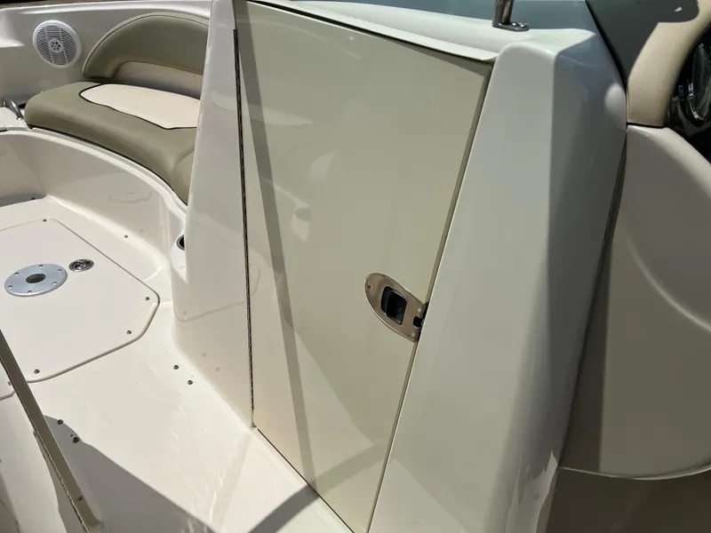 Slide: The Image of 2005 Sea Ray 220 Sundeck interior with seating and storage compartment. - 15