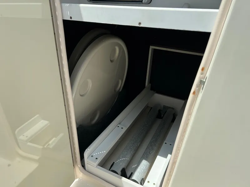 Slide: The Image of Storage compartment in a 2005 Sea Ray 220 Sundeck boat. - 17
