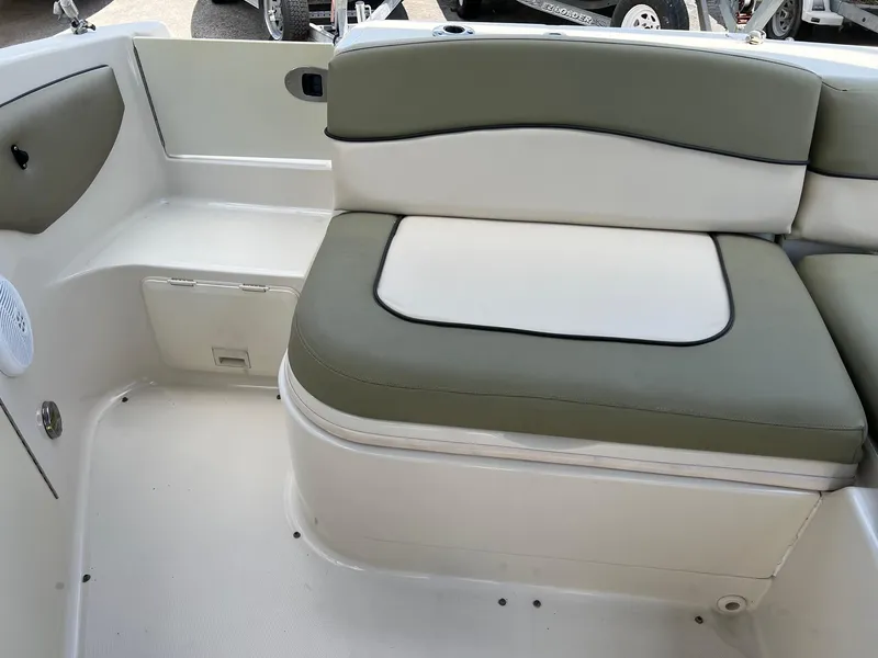 Slide: The Image of 2005 Sea Ray 220 Sundeck interior seating with green and white upholstery. - 18