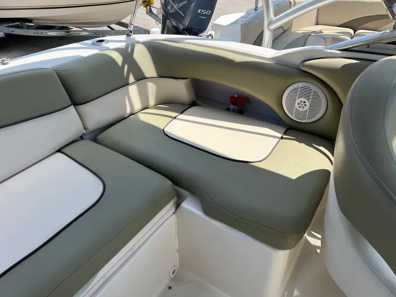 Slide: The Image of 2005 Sea Ray 220 Sundeck interior with cushioned seating and speaker. - 19