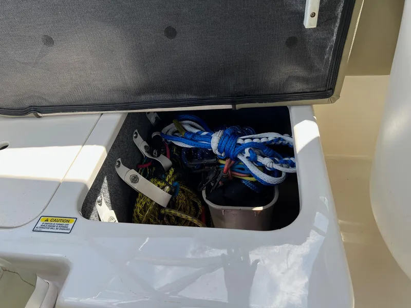 Slide: The Image of Storage compartment on a 2005 Sea Ray 220 Sundeck with ropes and equipment. - 20