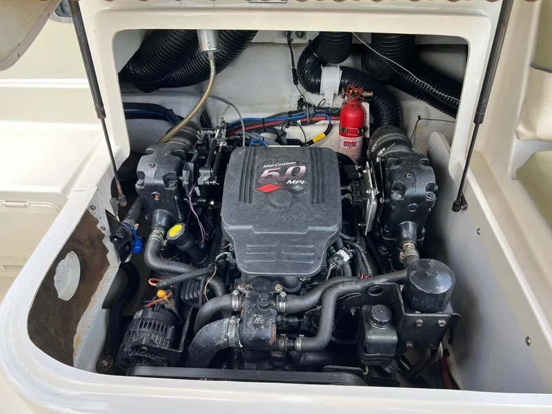 Slide: The Image of Engine compartment of a 2005 Sea Ray 220 Sundeck boat, featuring a 5.0 MPI engine. - 23