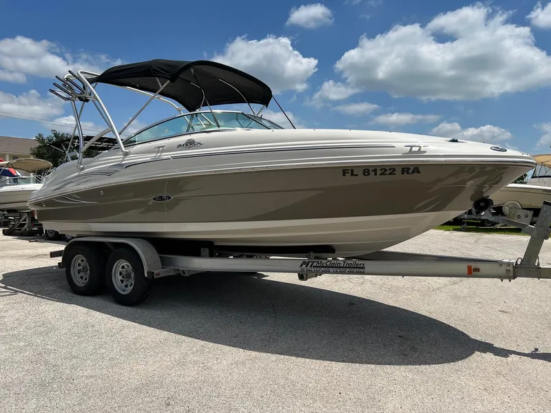 Slide: The Image of 2005 Sea Ray 220 Sundeck boat on trailer under blue sky. - 26