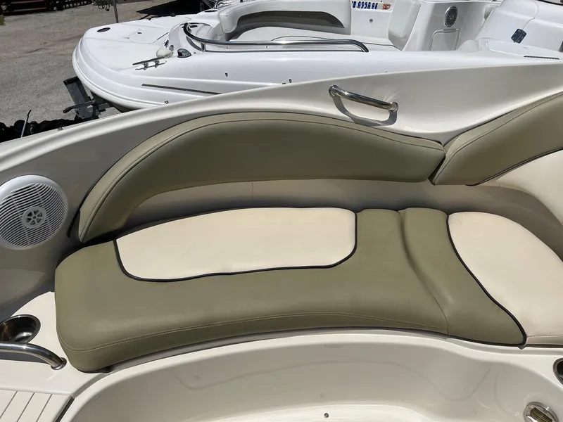 Slide: The Image of 2005 Sea Ray 220 Sundeck boat interior with beige and olive seating. - 6