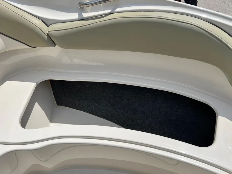 Slide: The Image of 2005 Sea Ray 220 Sundeck boat interior storage compartment with cushioned seating. - 7