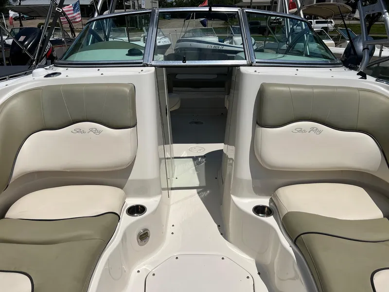 Slide: The Image of 2005 Sea Ray 220 Sundeck interior with beige seating and open deck layout. - 9