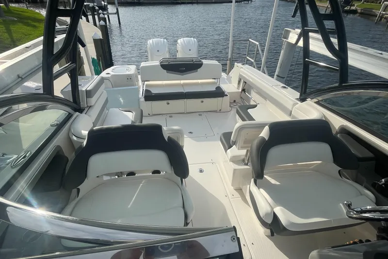 Slide: The Image of 2023 Robalo R317 Dual Console boat interior with seating and water view. - 11