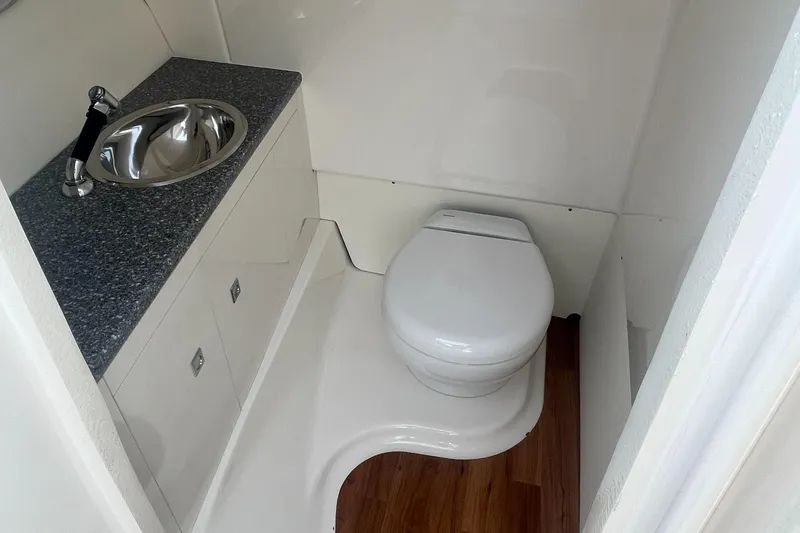 Slide: The Image of 2023 Robalo R317 Dual Console boat bathroom with sink and toilet. - 13