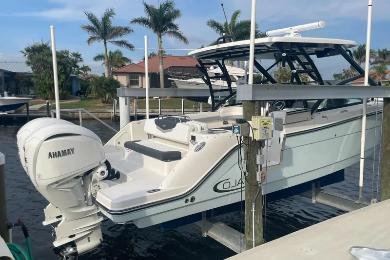 Slide: The Image of 2023 Robalo R317 Dual Console boat docked with Yamaha outboard motor. - 3