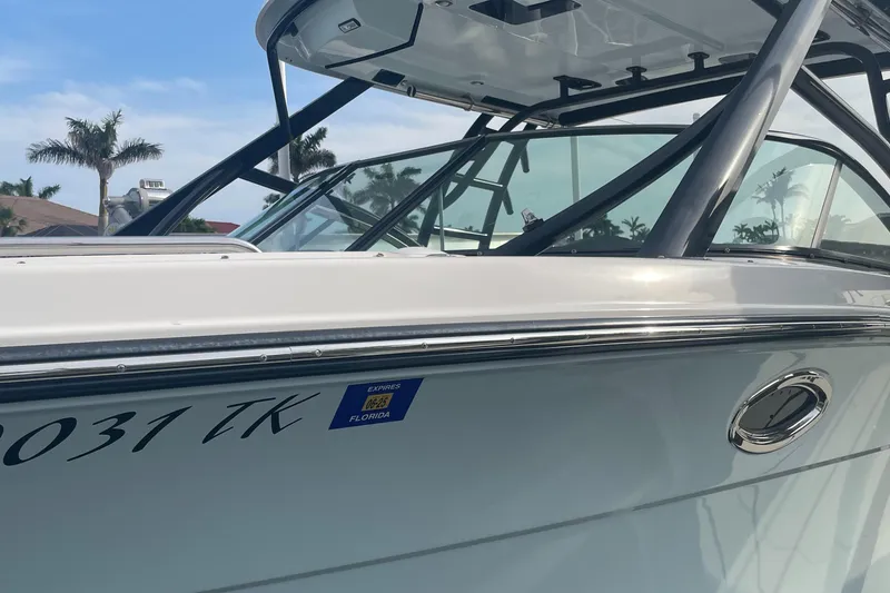 Slide: The Image of 2023 Robalo R317 Dual Console boat with sleek design and modern features. - 5