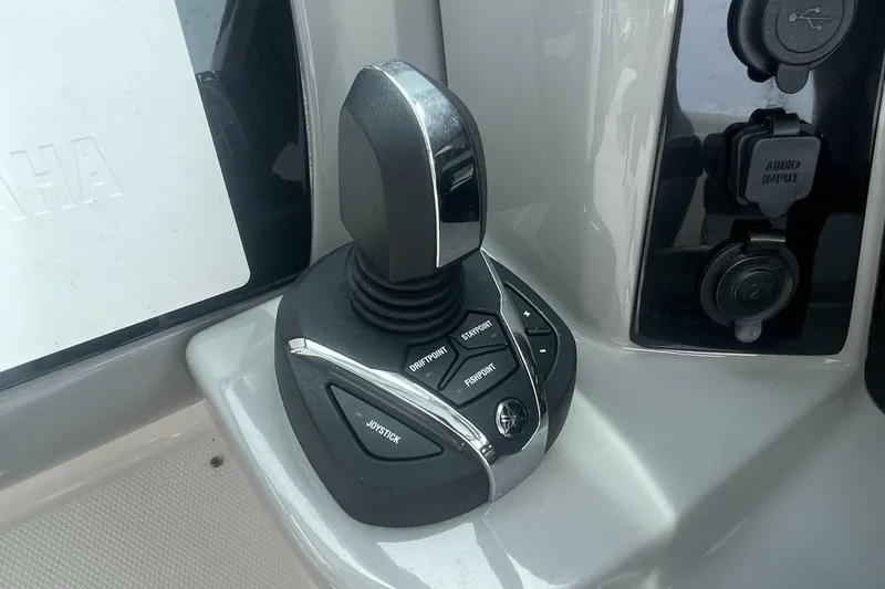 Slide: The Image of Joystick control on 2023 Robalo R317 Dual Console boat dashboard. - 7