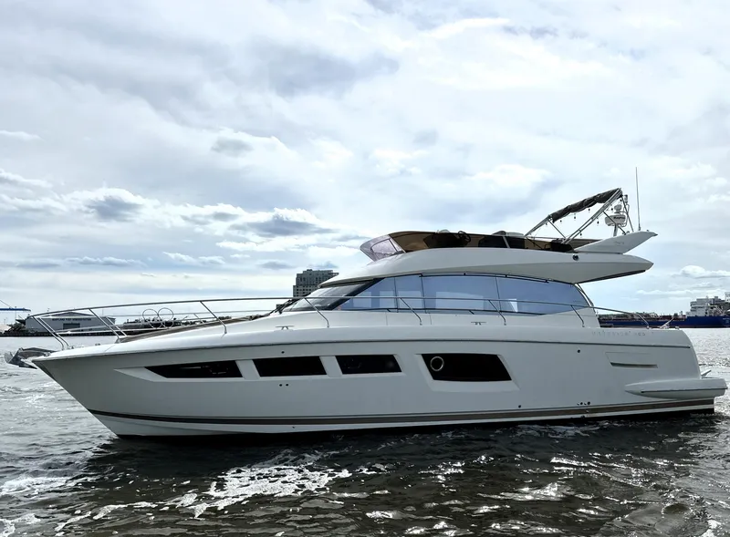 Slide: The Image of 2013 Prestige 500 yacht cruising on open water under cloudy skies. - 0