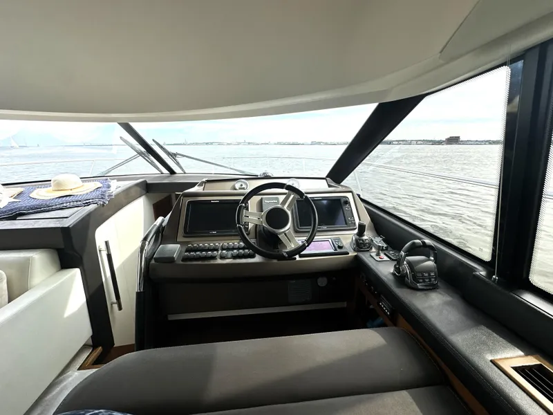 Slide: The Image of Interior view of 2013 Prestige 500 yacht cockpit with steering wheel and navigation equipment. - 25