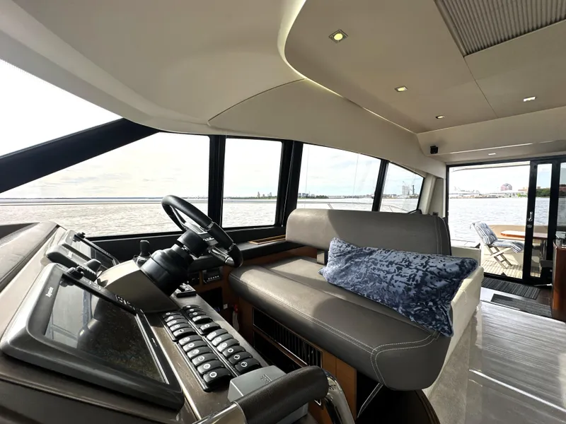 Slide: The Image of Interior of 2013 Prestige 500 yacht with helm, seating, and ocean view. - 26