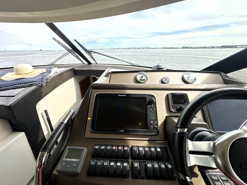 Slide: The Image of Cockpit of 2013 Prestige 500 yacht with navigation controls and steering wheel. - 28