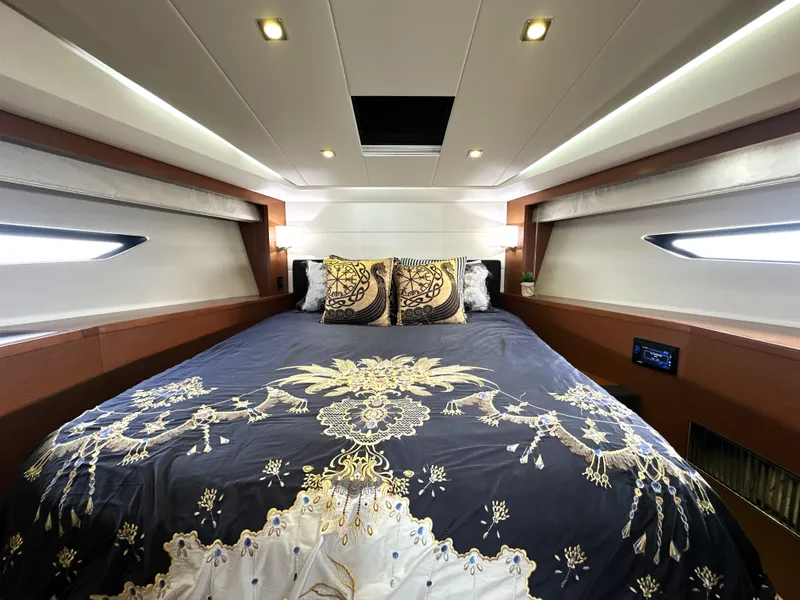 Slide: The Image of Luxurious cabin interior of a 2013 Prestige 500 yacht with elegant bedding and ambient lighting. - 33
