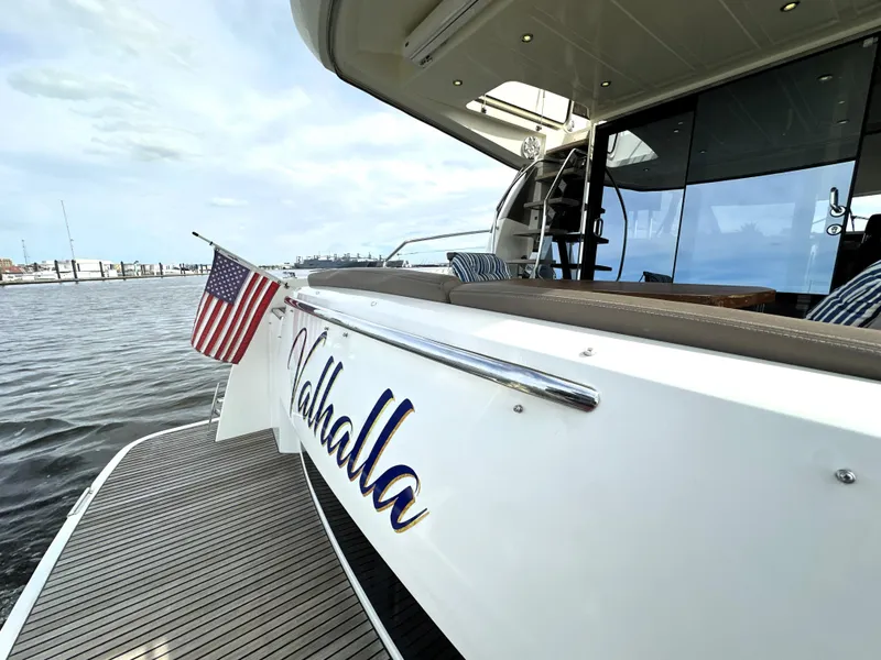 Slide: The Image of Luxury yacht "Valhalla" docked, featuring American flag, Prestige 500 model, 2013. - 4