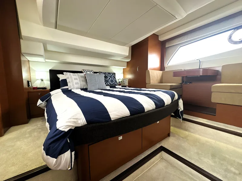 Slide: The Image of Luxurious cabin interior of a 2013 Prestige 500 yacht with striped bedding and modern furnishings. - 43