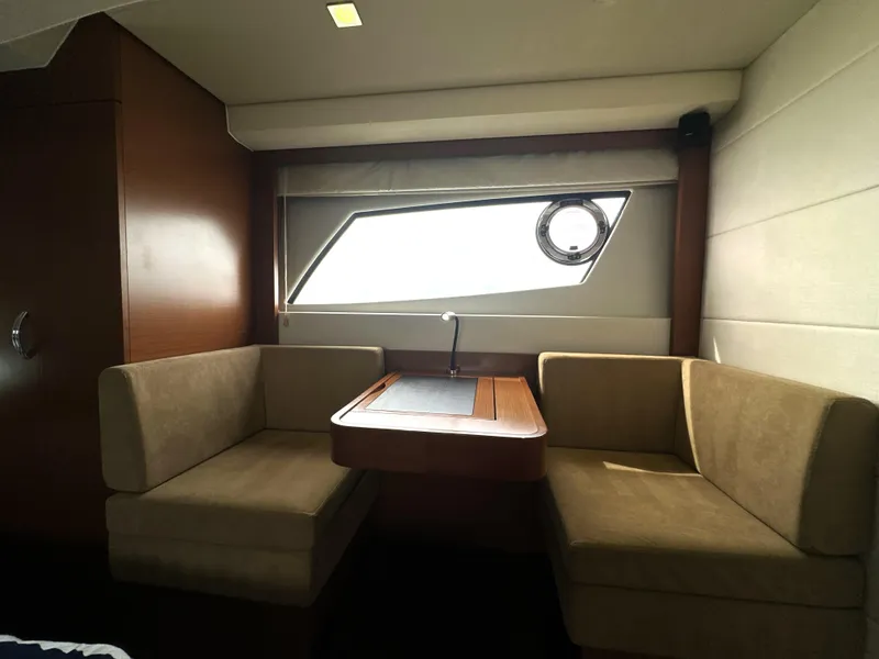 Slide: The Image of Interior of a 2013 Prestige 500 yacht with cozy seating and a window view. - 45
