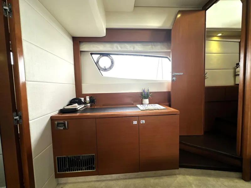 Slide: The Image of Interior of 2013 Prestige 500 yacht with wooden cabinetry and porthole window. - 46
