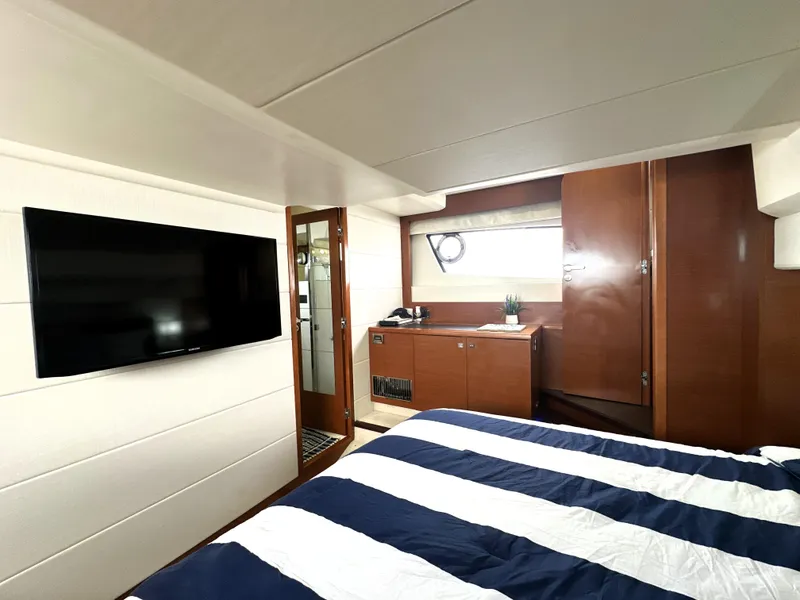 Slide: The Image of Luxurious cabin interior of 2013 Prestige 500 yacht with modern amenities and striped bedding. - 47