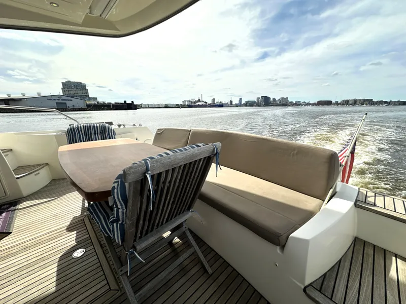 Slide: The Image of Luxury yacht deck with seating area, Prestige 500, 2013 model, cruising on open water. - 7