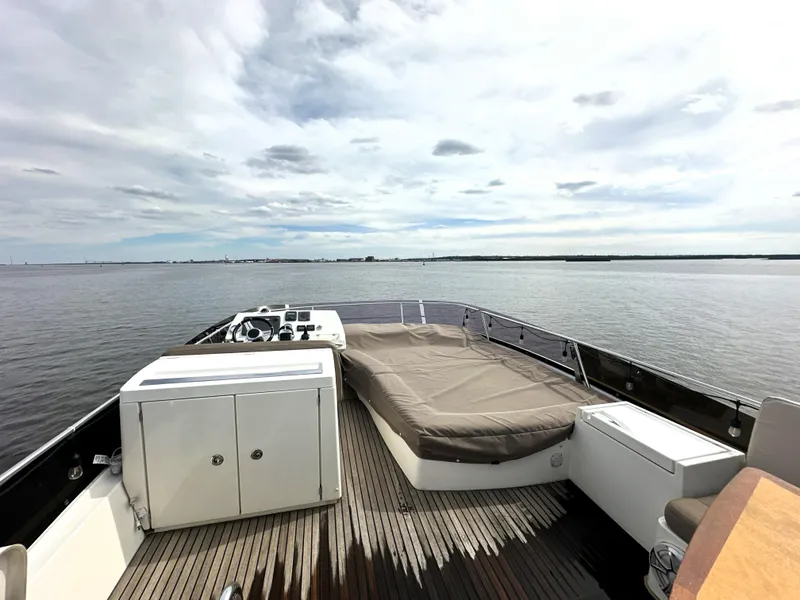 Slide: The Image of Prestige 500 yacht deck, 2013 model, featuring spacious seating and scenic water view. - 9