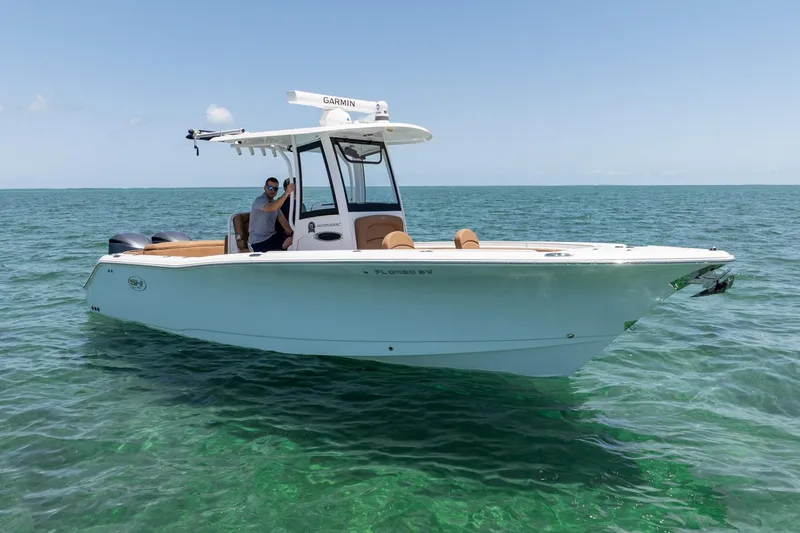 Slide: The Image of 2021 Sea Hunt Ultra 275 SE boat on clear ocean water, sunny day. - 11