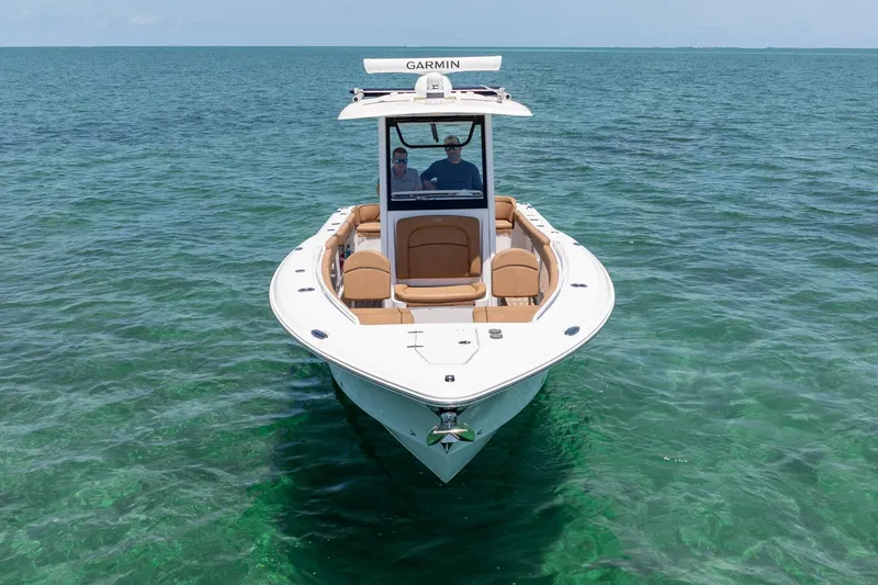 Slide: The Image of 2021 Sea Hunt Ultra 275 SE boat on clear ocean water. - 12