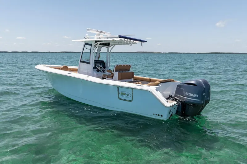 Slide: The Image of 2021 Sea Hunt Ultra 275 SE boat on clear turquoise water, featuring Yamaha outboard motor. - 13