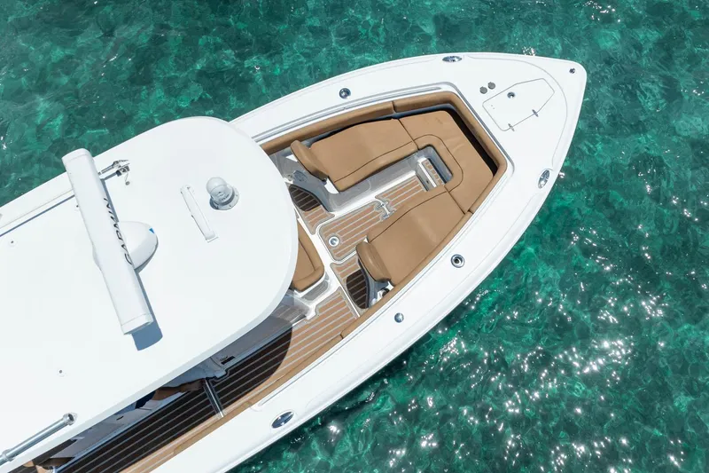 Slide: The Image of 2021 Sea Hunt Ultra 275 SE boat on clear turquoise water, aerial view. - 16