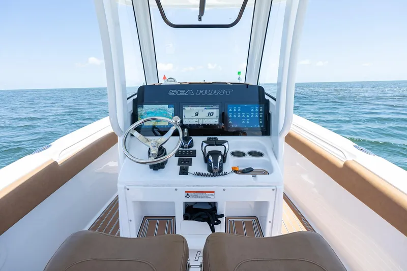 Slide: The Image of 2021 Sea Hunt Ultra 275 SE boat dashboard with ocean view. - 19
