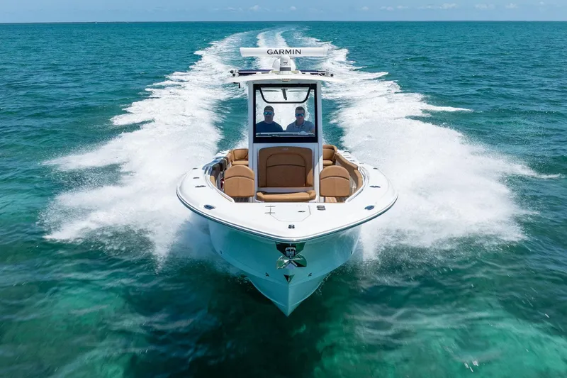Slide: The Image of 2021 Sea Hunt Ultra 275 SE cruising on clear blue ocean waters. - 2