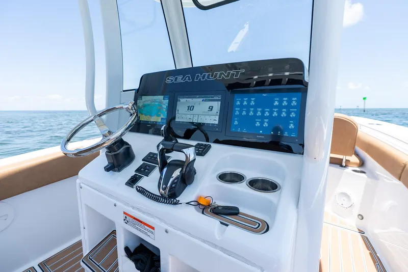 Slide: The Image of 2021 Sea Hunt Ultra 275 SE boat dashboard with navigation screens and controls. - 20