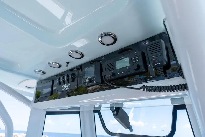 Slide: The Image of 2021 Sea Hunt Ultra 275 SE boat dashboard with modern navigation and communication equipment. - 23