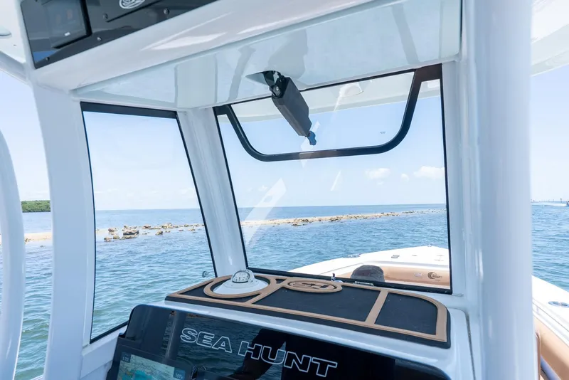 Slide: The Image of 2021 Sea Hunt Ultra 275 SE boat interior with ocean view through windshield. - 24