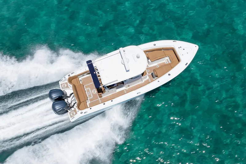 Slide: The Image of 2021 Sea Hunt Ultra 275 SE boat cruising on clear turquoise water. - 3