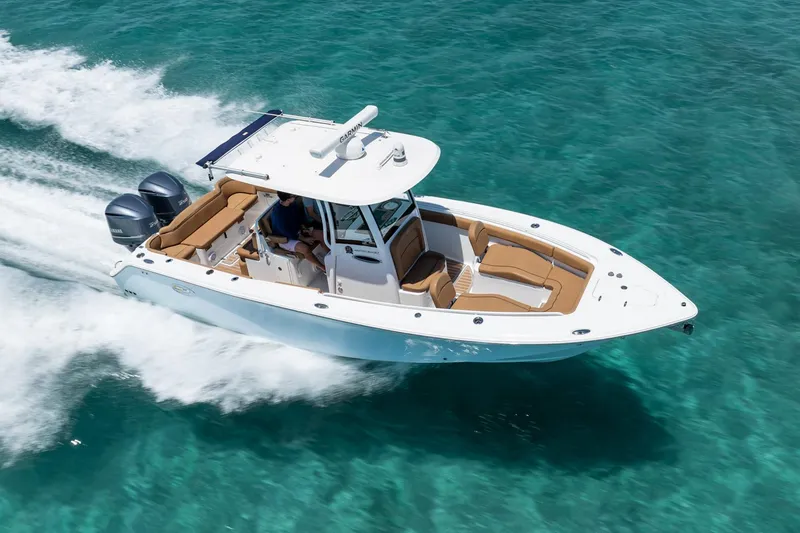 Slide: The Image of 2021 Sea Hunt Ultra 275 SE boat cruising on clear turquoise water. - 4