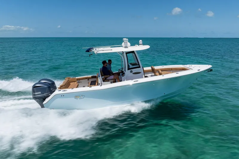 Slide: The Image of 2021 Sea Hunt Ultra 275 SE boat cruising on clear blue ocean water. - 5