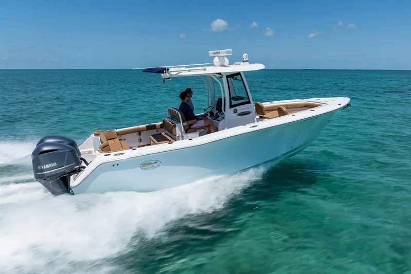 Slide: The Image of 2021 Sea Hunt Ultra 275 SE boat cruising on clear turquoise water. - 6